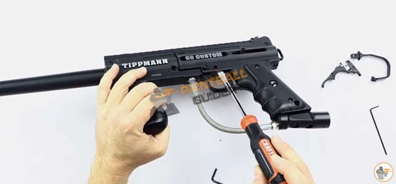 Unscrewing The Tippmann Custom 98 Paintball Gun To Install Double Trigger Kit